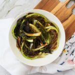 Bowl of roasted cauliflower leaves.