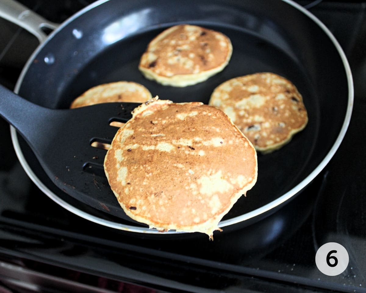 Pancakes cooking in a frying pan.